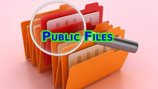 Cardboard and paper files with magnifying glass